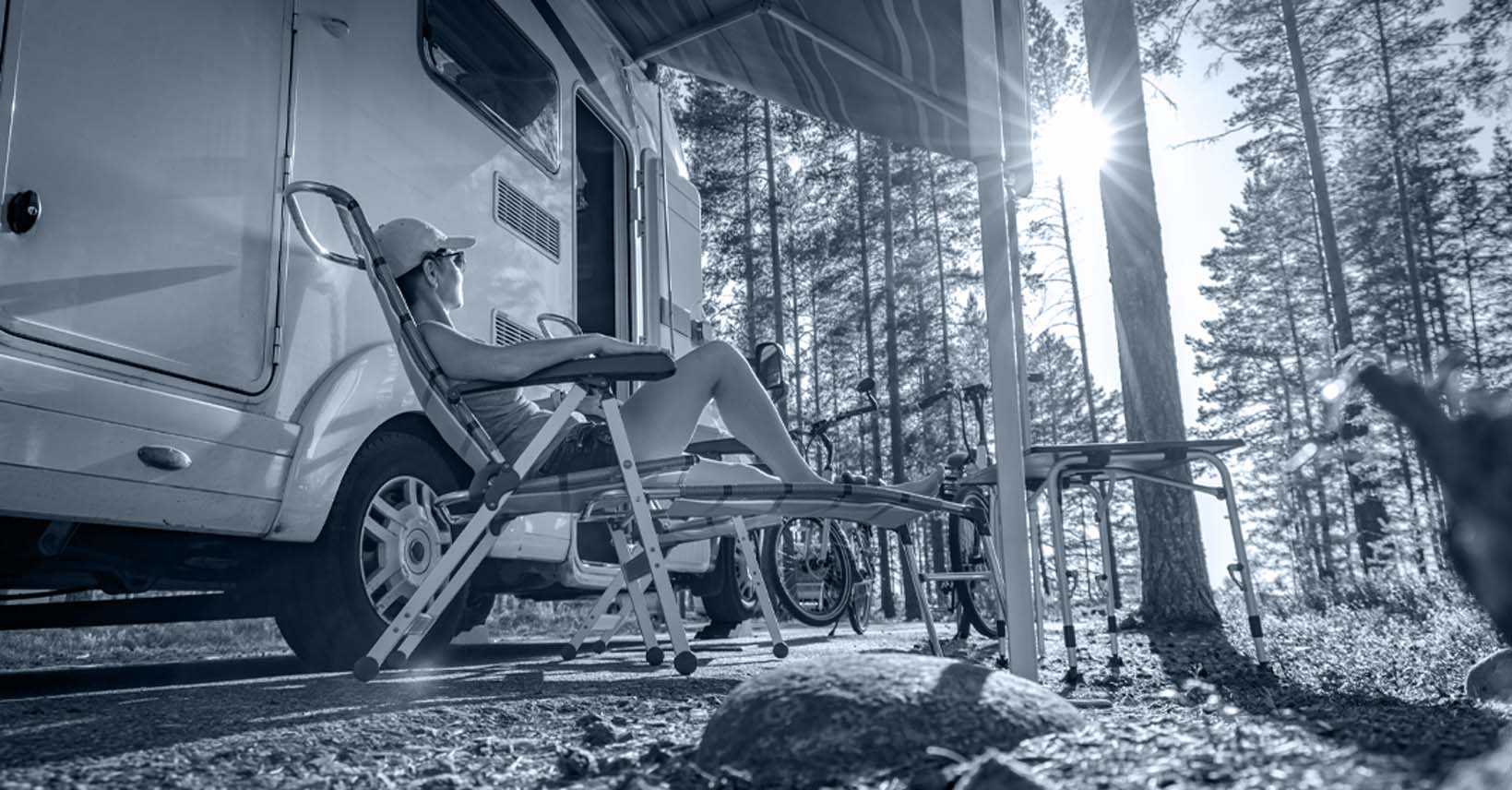 RV exterior with person sitting on a lawn chair